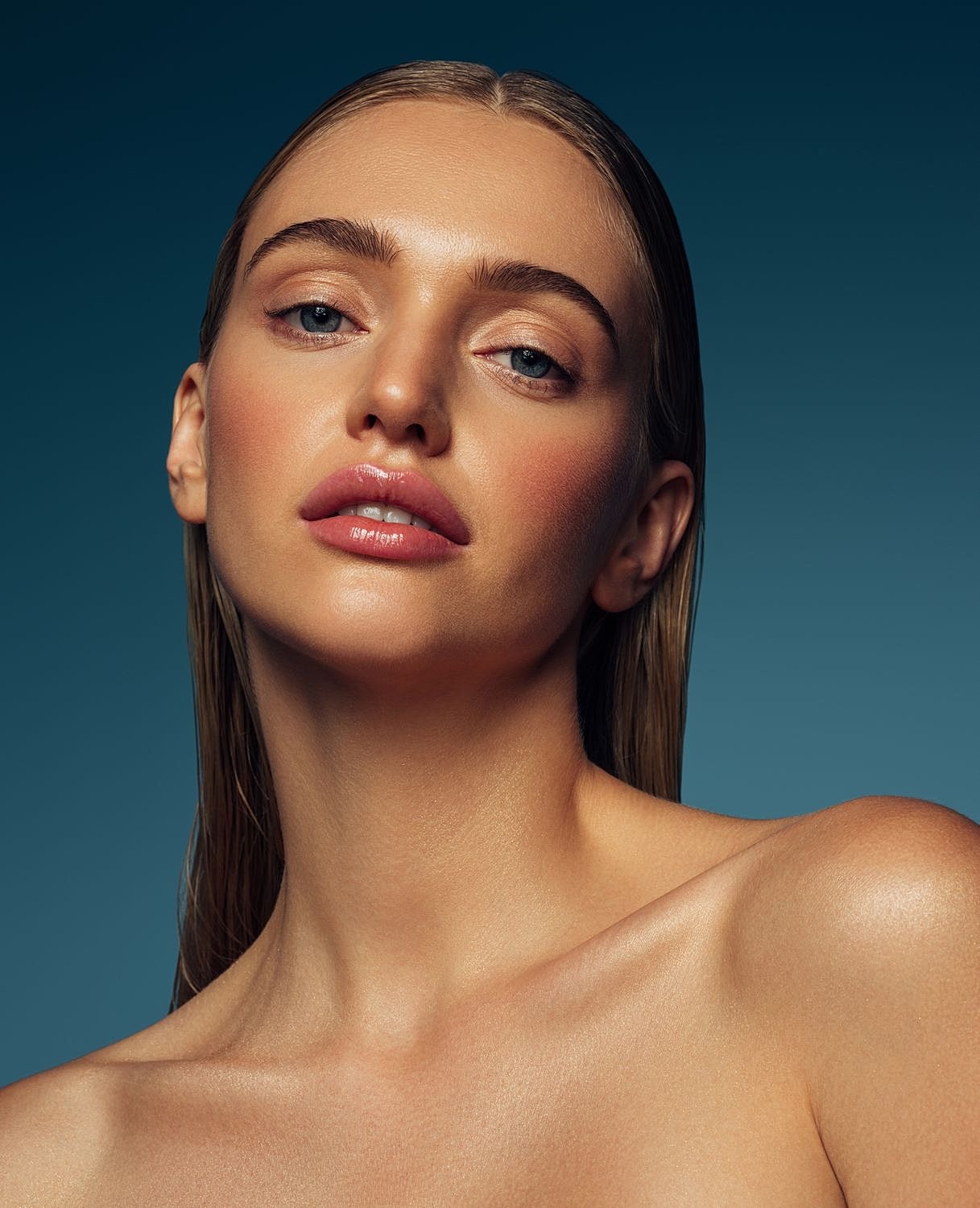 Model in black outfit against solid background