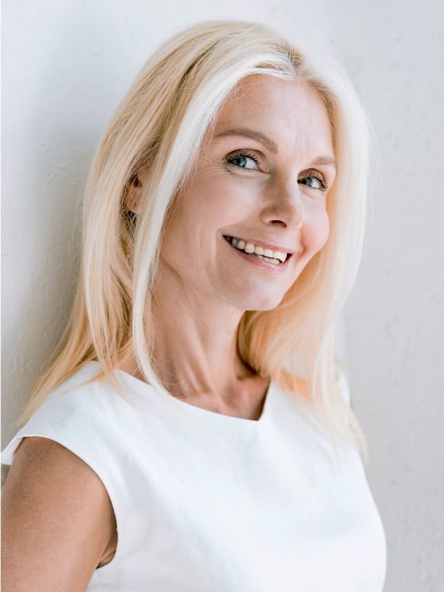 Smiling woman with long blonde hair.